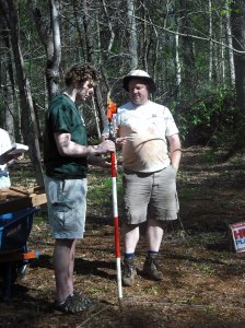 Don Gaylord (right) shows Ian Dexter '12 how to take elevations with a stadia rod and total station