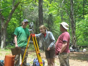 Tyler Thompson '11 and Monticello archaeologist Don Gaylord watch Alex Massey '10 take site elevations using a total station 